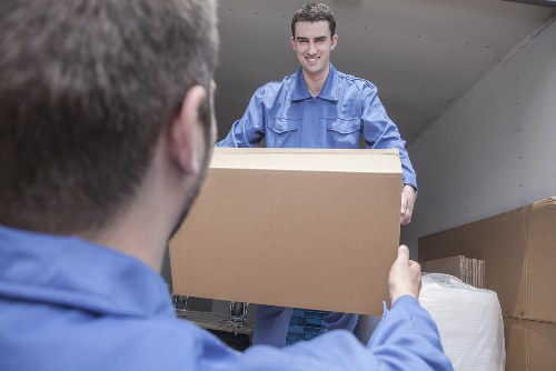 Mover sorting recyclable packing materials during a Hampstead house move