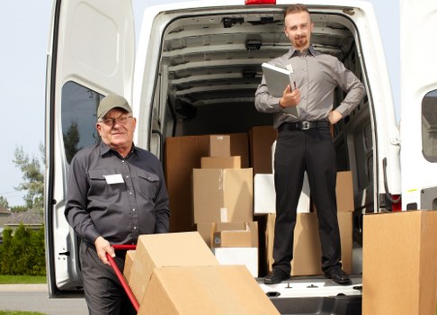 Man with van loading furniture on a Hampstead residential street