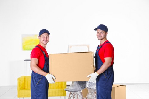 Team member handling moving boxes safely with a trolley