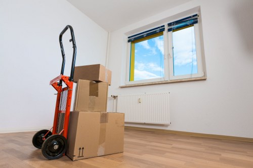 Removal vehicle loading household boxes near a Hampstead flat